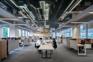 Three people working in an office.